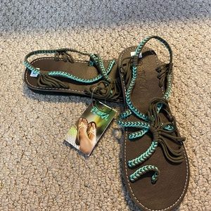 Brown and teal Plaka sandals.